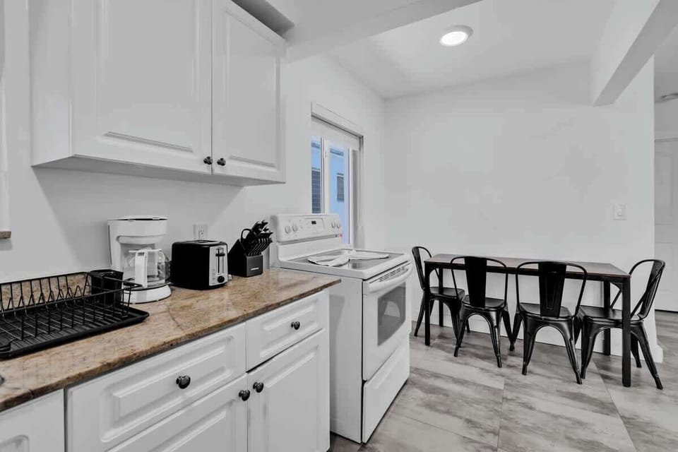 Functional kitchen and dining space with espresso machine and seating for six—great for long stays or family trips.