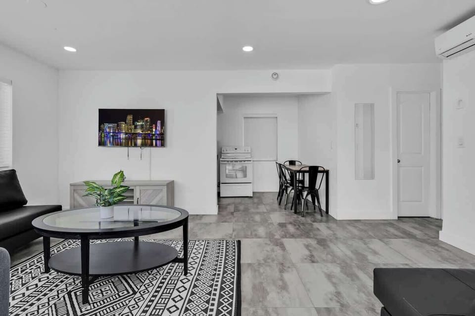 Open-concept living and dining area with smart TV and cozy furnishings—great for couples or small groups.