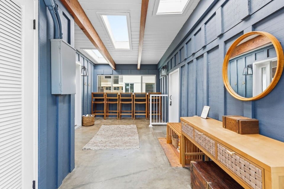 Shared 2nd-floor covered deck and entry featuring high chairs with a view, shared between the 2BR unit and ADU.