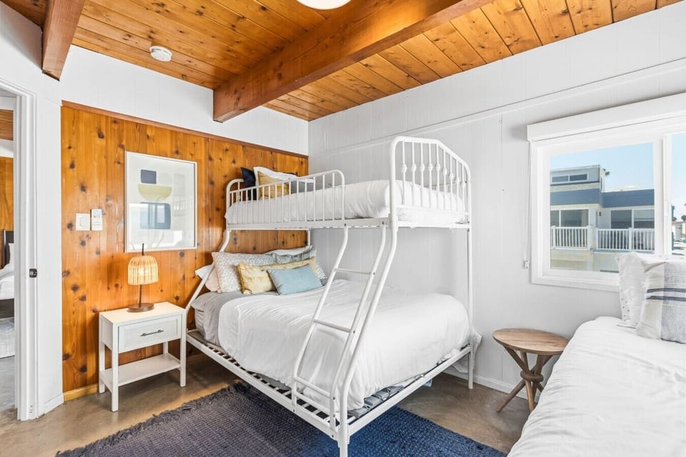 Second bedroom featuring a Twin-over-Full bunk bed plus an additional Twin bed, perfect for kids or extra guests.`
