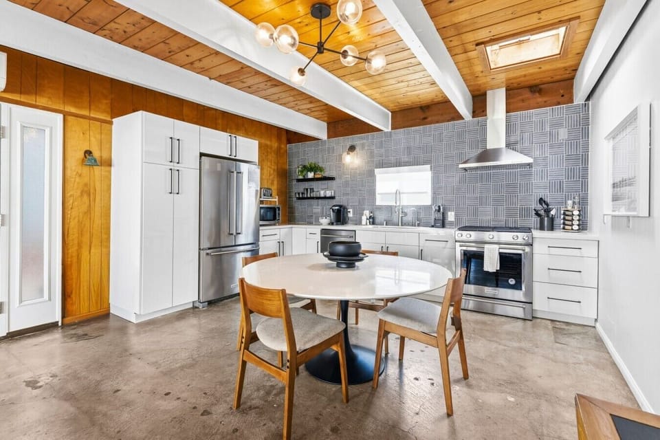 Fully equipped modern kitchen featuring stainless steel appliances and dining space for gathering.