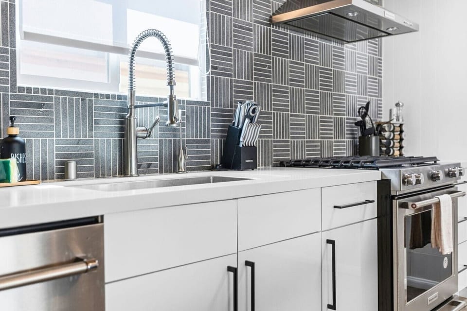 Bright kitchen and dining space with brand-new appliances, quality cookware, and seating for group meals.
