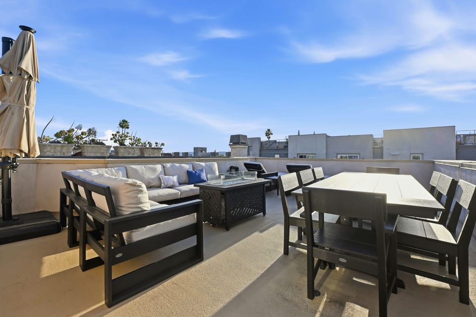 Plentiful outdoor seating and a large dining table for family gatherings, all overlooking the ocean.