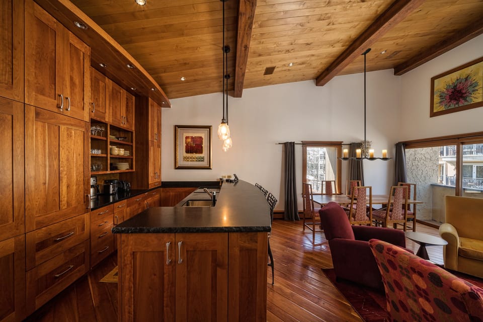 Open kitchen/living room/dinging room floorplan with views of mountain/village.