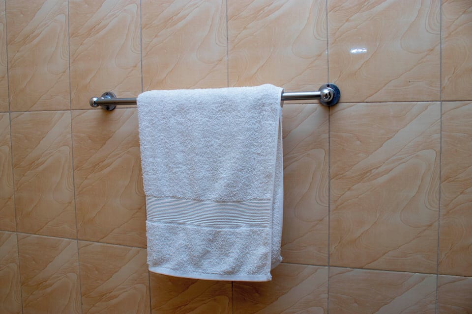 Shower, rainfall showerhead, slippers, towels