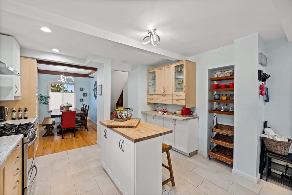 Gather with friends and family around the spacious kitchen island, complete with extra seating that ensures everyone has a place to enjoy culinary delights in this fully stocked kitchen. 