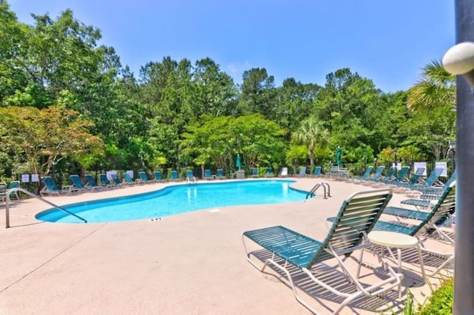 Take a cool dip in the sparkling pool after a fun day at the beach.