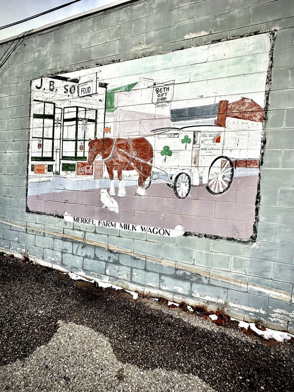 Mural of the Hill Dale Dairy Wagon on the side of a building downtown