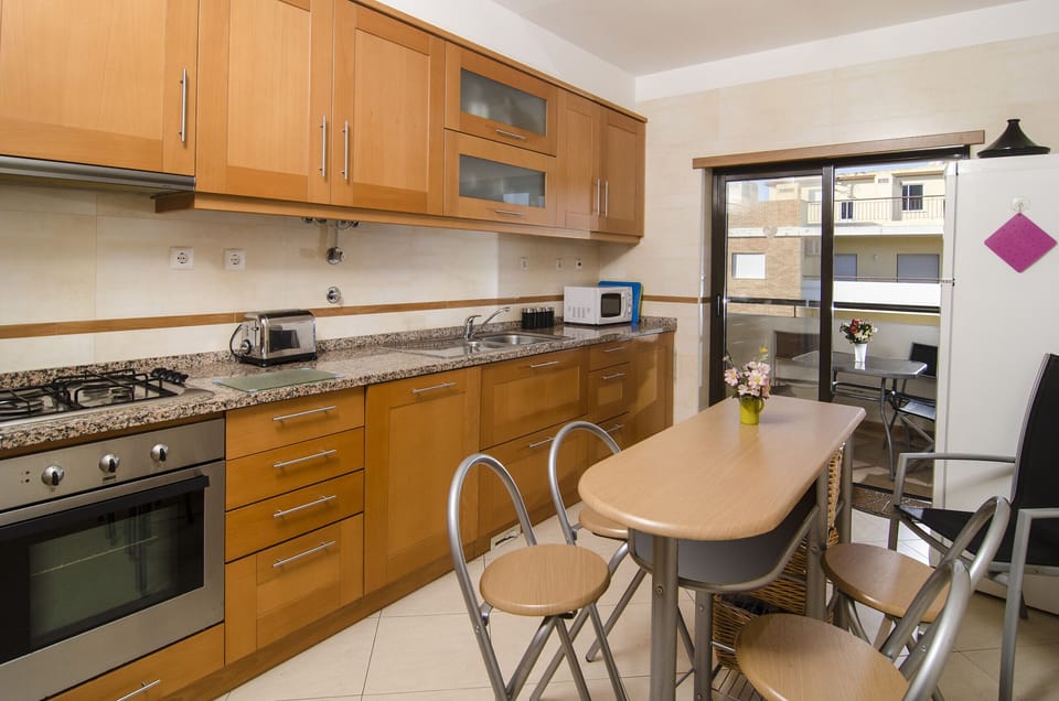 Kitchen with small dining table in the centre