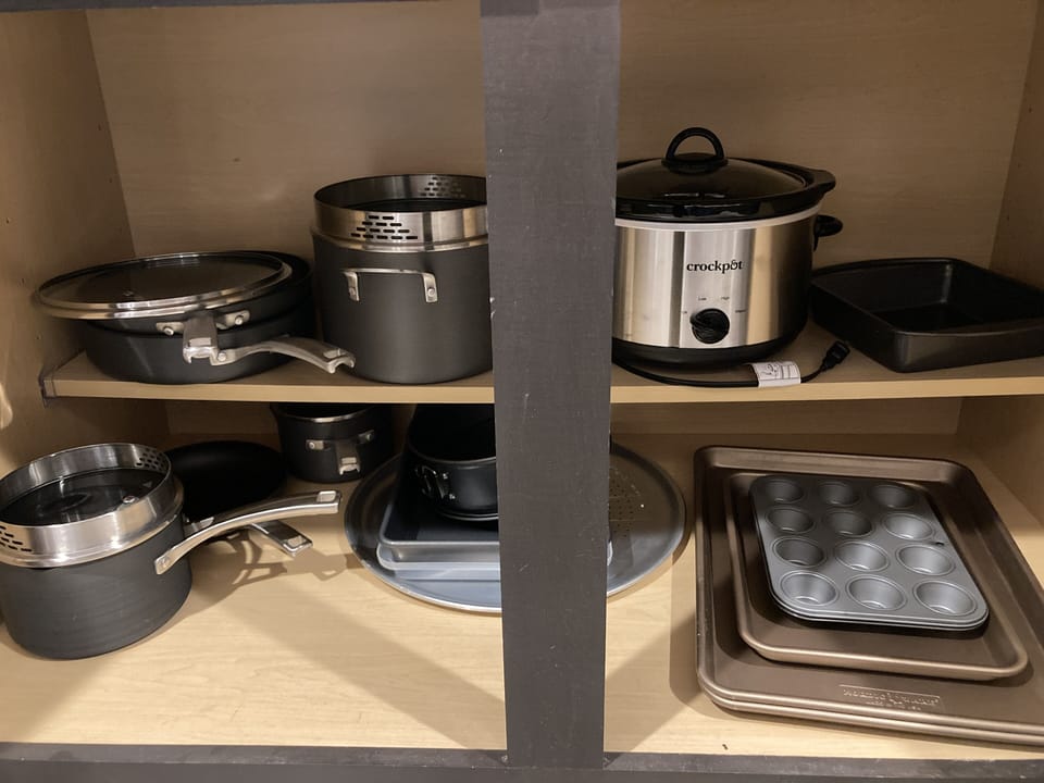 Stocked with the pots, pans, baking dishes and crockpot for your chef's needs.
