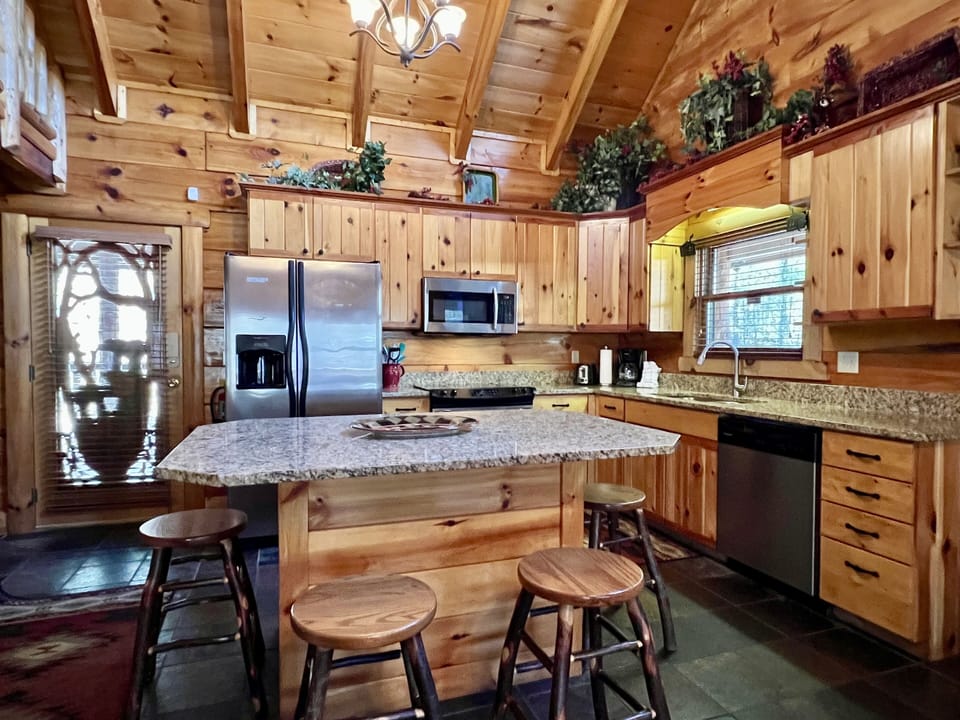 The kitchen space has ample counters plus a generously sized dining island