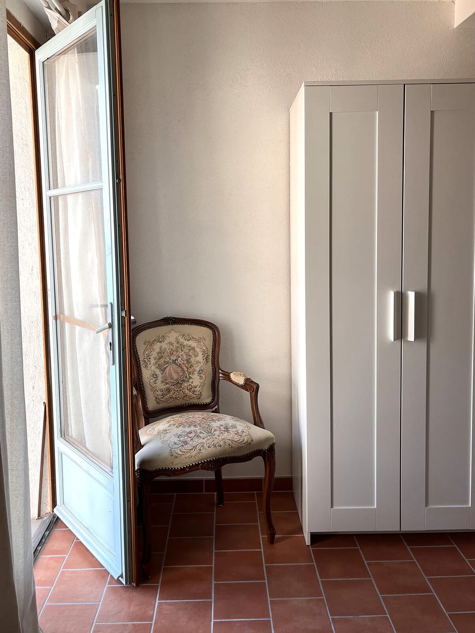 The second bedroom with a double bed and a bathroom area