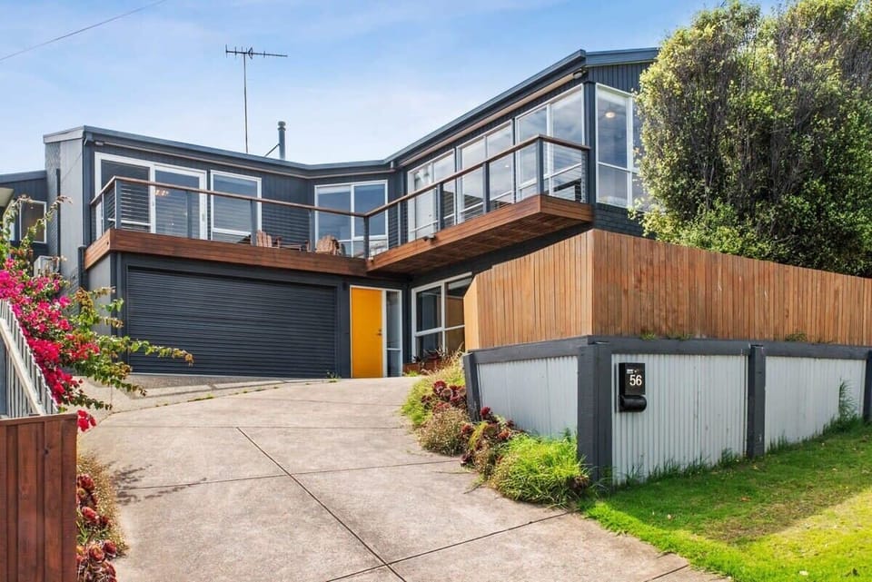 Relax on the deck and enjoy sweeping views of endless sand dunes from this elevated family beach house