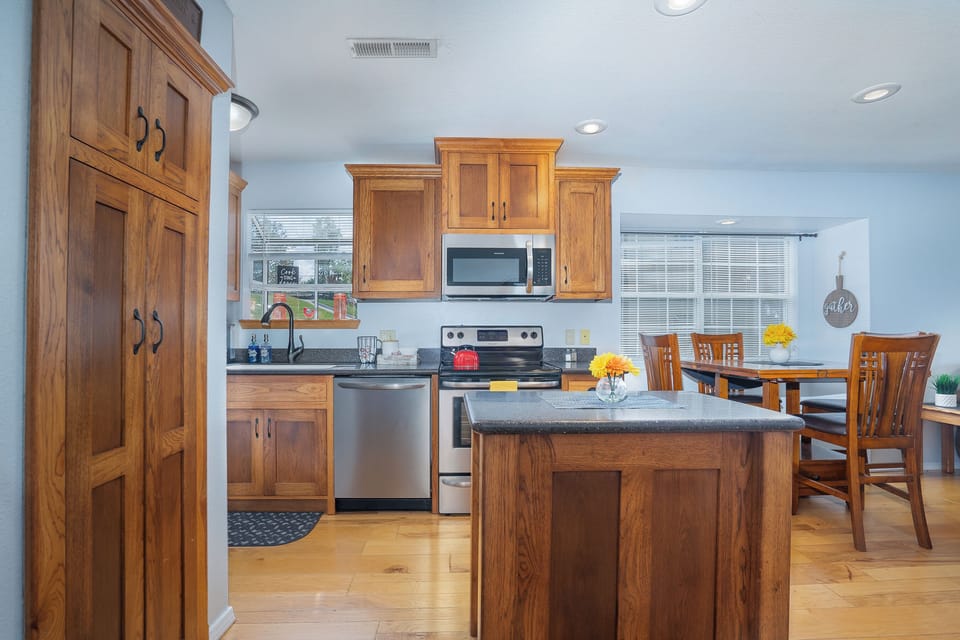 Warm and inviting, this kitchen features stunning cherry wood cabinets that add a touch of classic elegance.