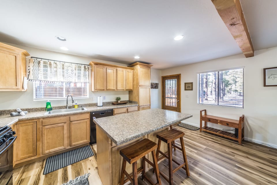 Fully stocked kitchen with dishes, utensils, and cooking ware.
