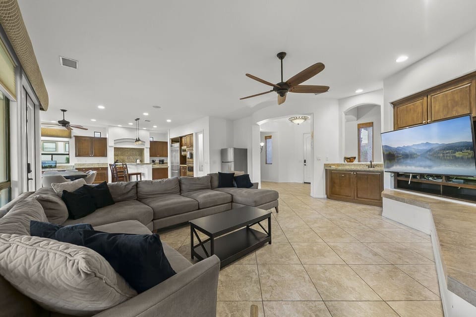 The living room offers ample seating for eight, ideal for movie nights or casual conversations.