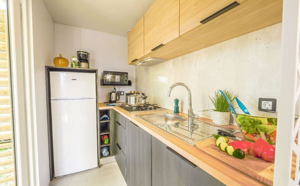 A well-equipped kitchen with warm, natural tones, perfect for preparing home-cooked meals.