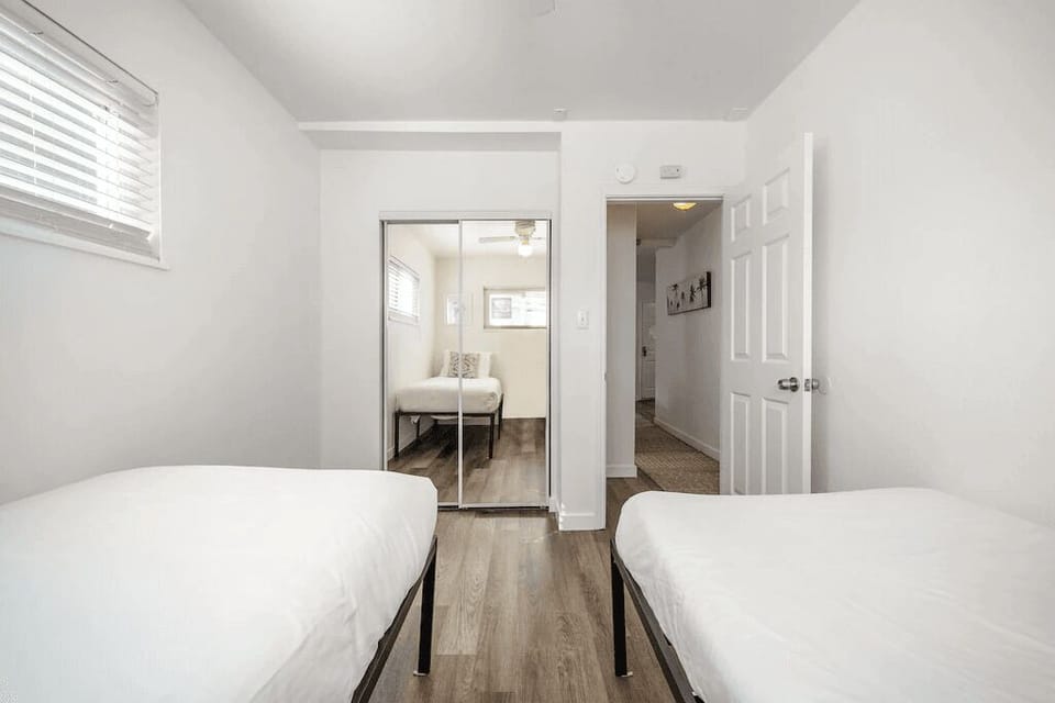 The second guest bedroom includes two twin beds.
                