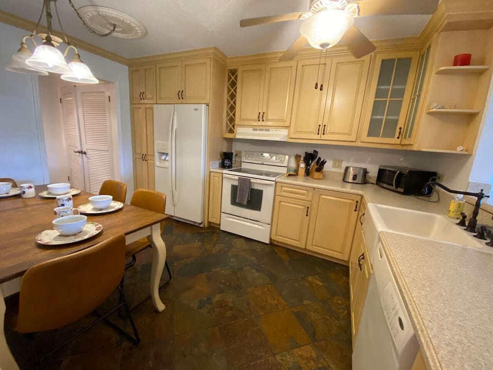 Light cabinetry, full sized appliances, and a dining table the whole group can gather around