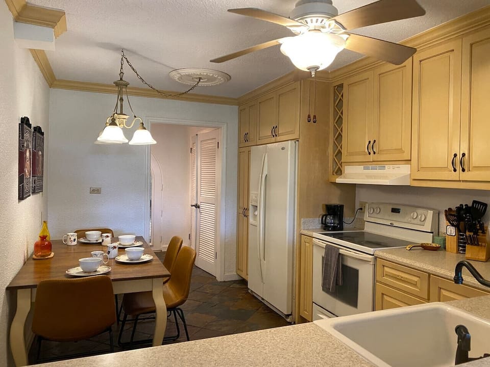 Kitchen and Dining Area with Pendant Light and Ceiling Fan
