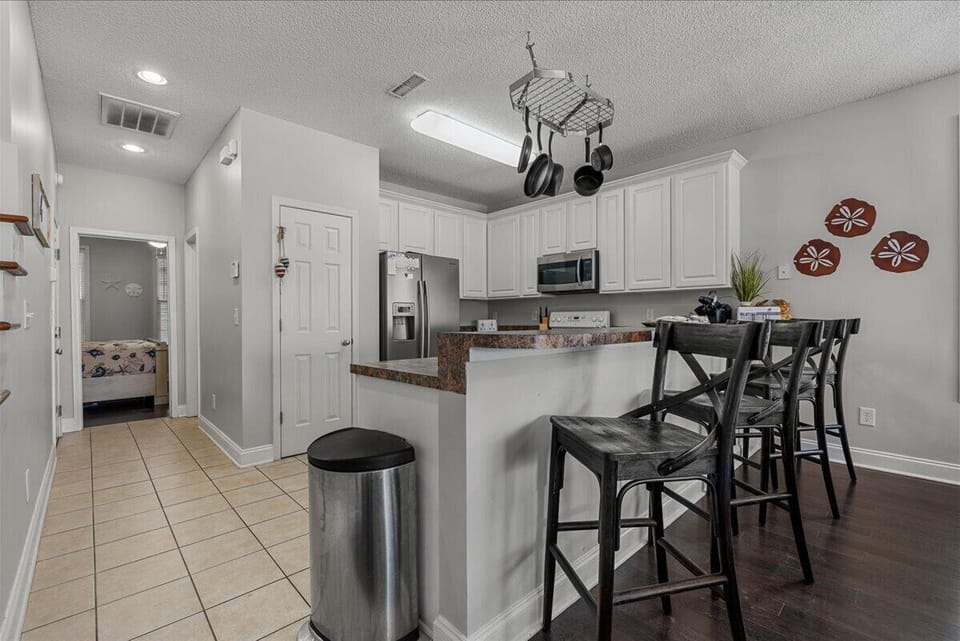 Your spacious kitchen features modern appliances, granite counters, and a breakfast bar where you can enjoy morning coffee together.