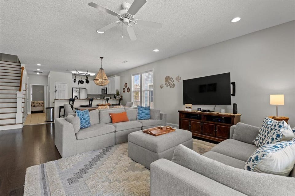 Sink into plush sectional seating where you'll gather for movie nights and morning coffee in this bright, open-concept space.