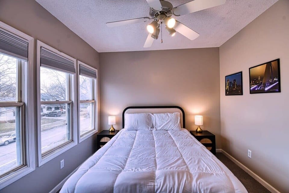 【Bedroom 4】 Queen bed — natural light from 3 windows