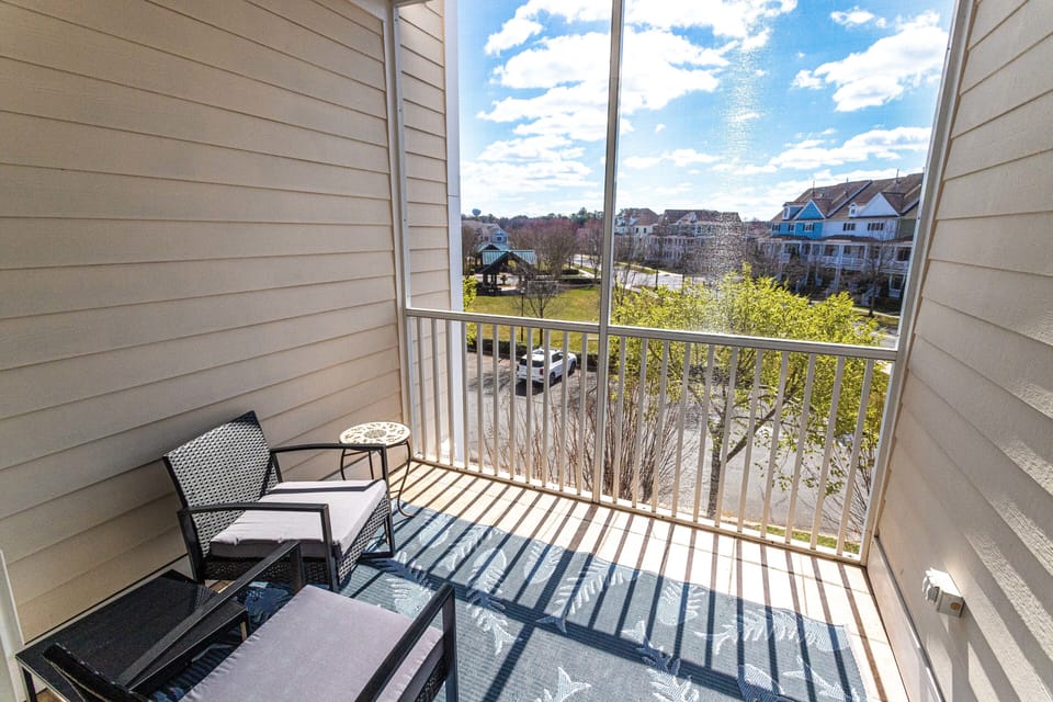 Screened in porch overlooking community green space 