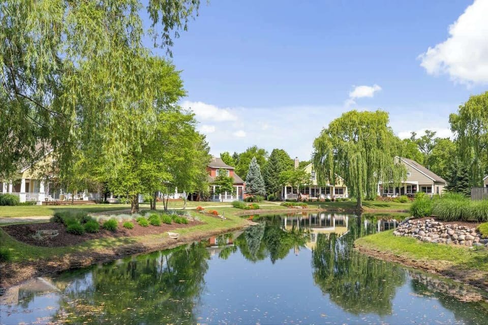 Enjoy the serene pond and beautiful greenery on this tranquil property.