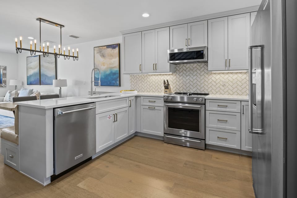 Create culinary masterpieces in this modern kitchen with sleek gray cabinets, granite counters, and premium stainless steel appliances.