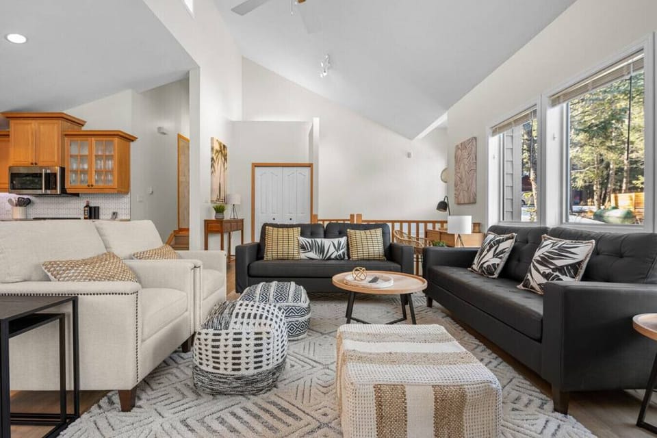 Living room with a Smart TV, cozy seating options and walkout access to the upper balcony.