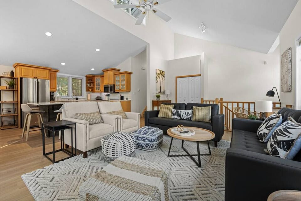 Living room with a Smart TV, cozy seating options and walkout access to the upper balcony.
