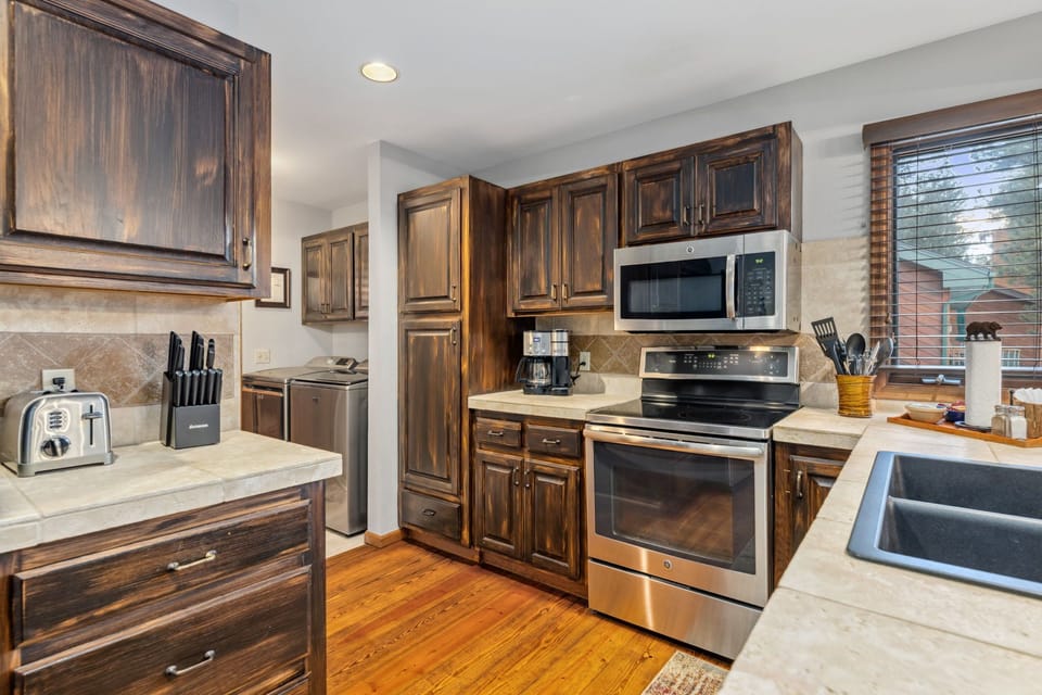 Stainless steel fridge, stove, dishwasher and microwave.  High quality cookware.