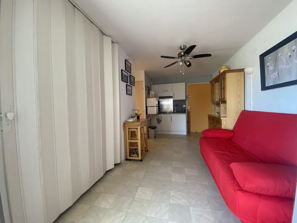 The living room is separated by a sliding door where there is a double bed