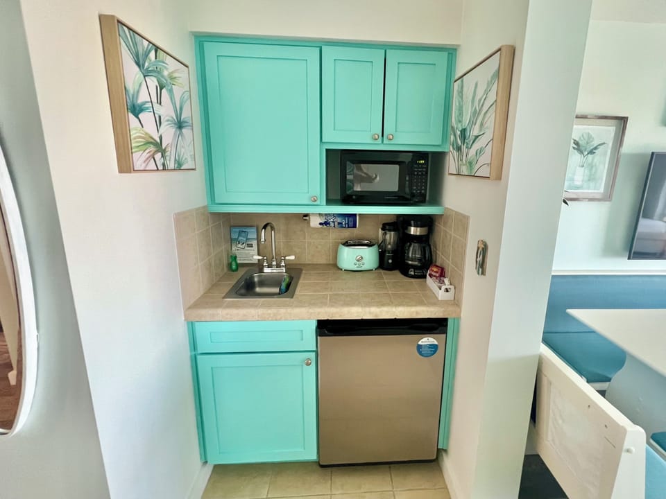 Kitchenette w/microwave, fridge, toaster, coffee, electric griddle & frying pan.