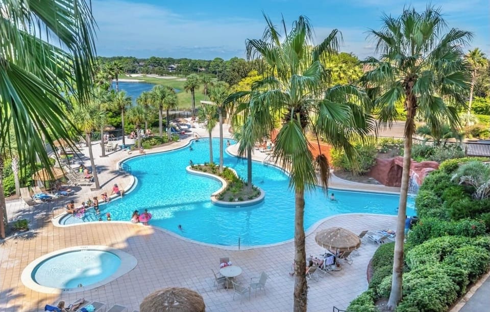 Luau pool includes a tiki bar, swim-under waterfall, kiddie pool and a hot tub. 