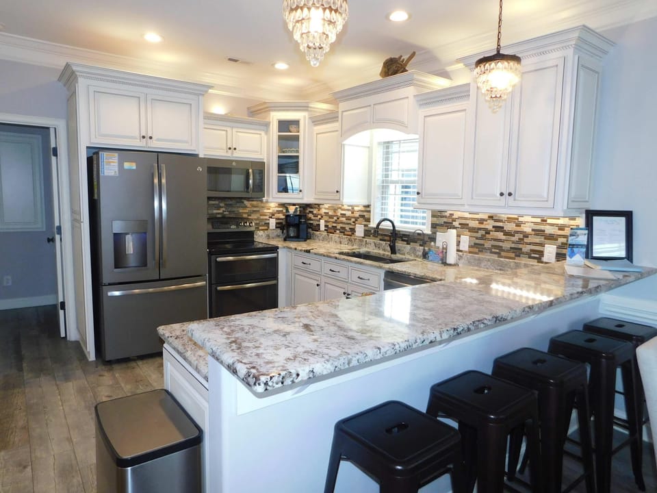 Modern kitchen with granite countertops and breakfast bar seating