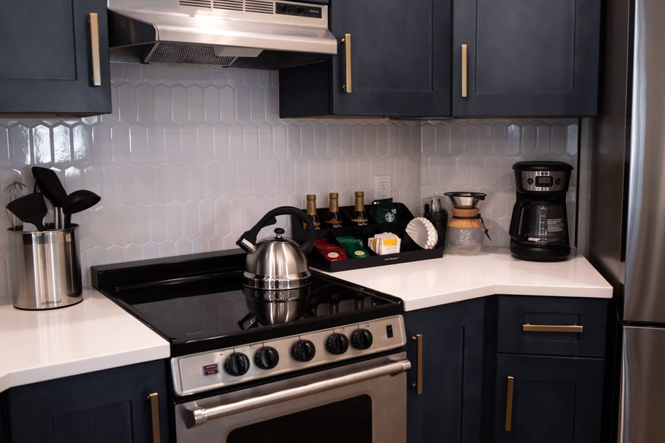 Kitchen range with overhead fan.