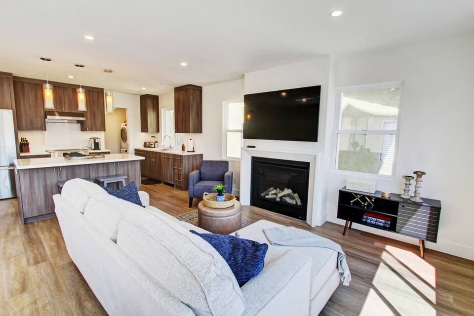The Beautifull comfortable living room with a large 60in television and a gas fireplace.  