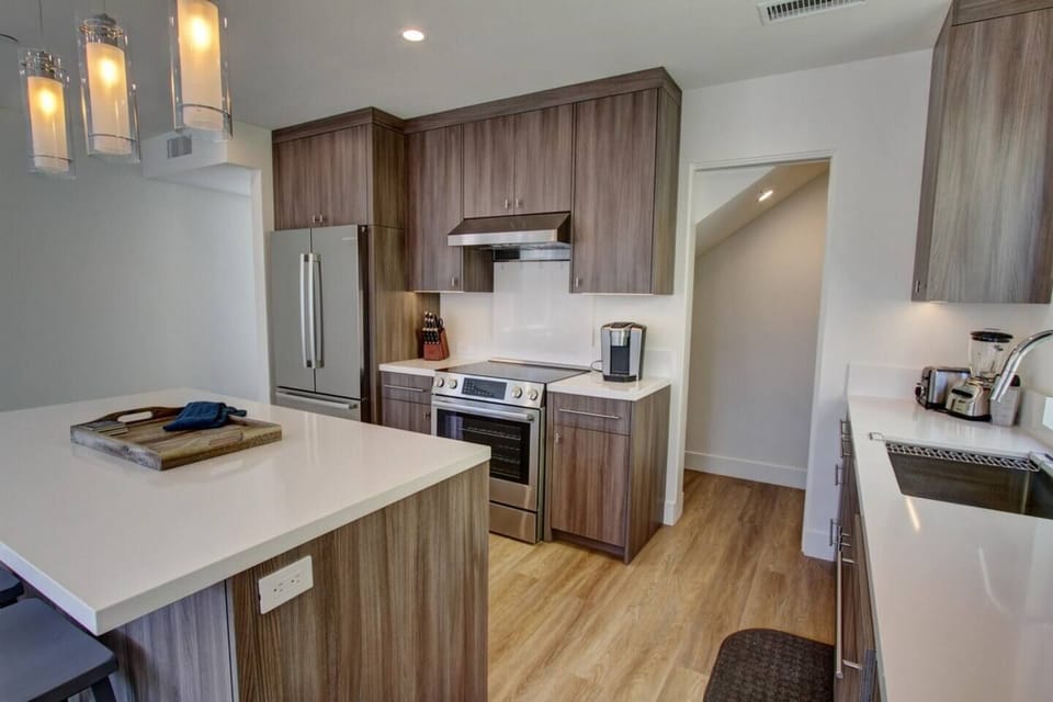 Kitchen area. the doorway leads to the laundry area with a stackable washer and dryer. 