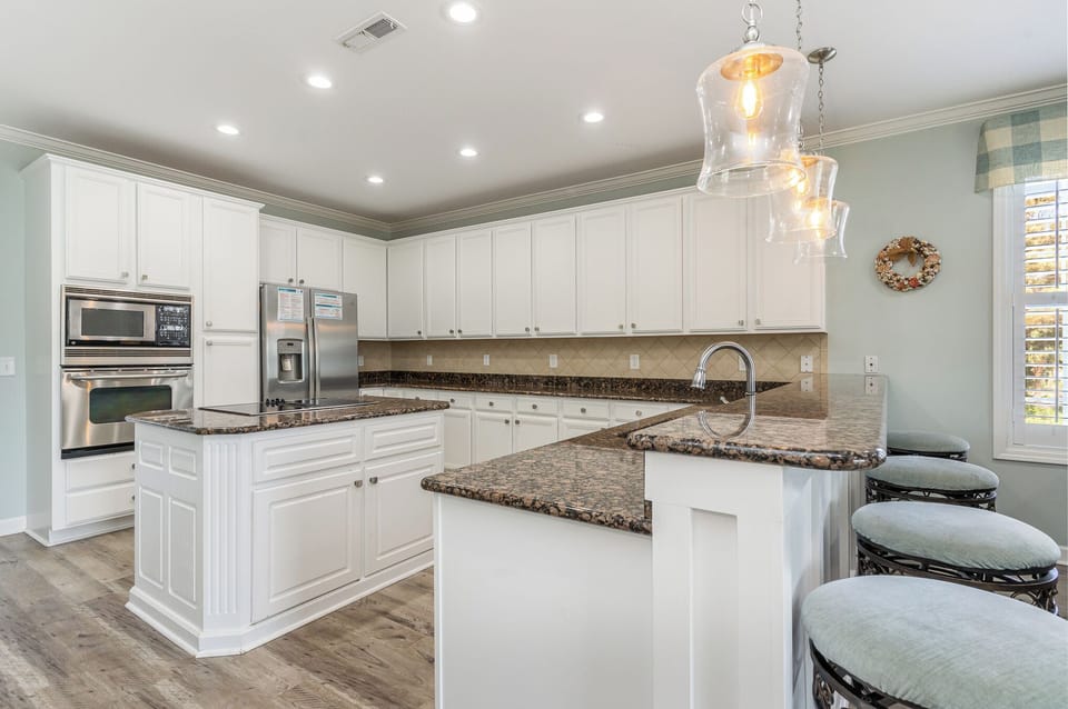 Your spacious kitchen features granite countertops, stainless steel appliances, and elegant pendant lighting for memorable meal preparation.