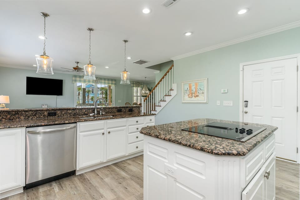 Your gourmet kitchen awaits with granite counters, modern appliances, and elegant pendant lighting - perfect for creating memorable meals together.
