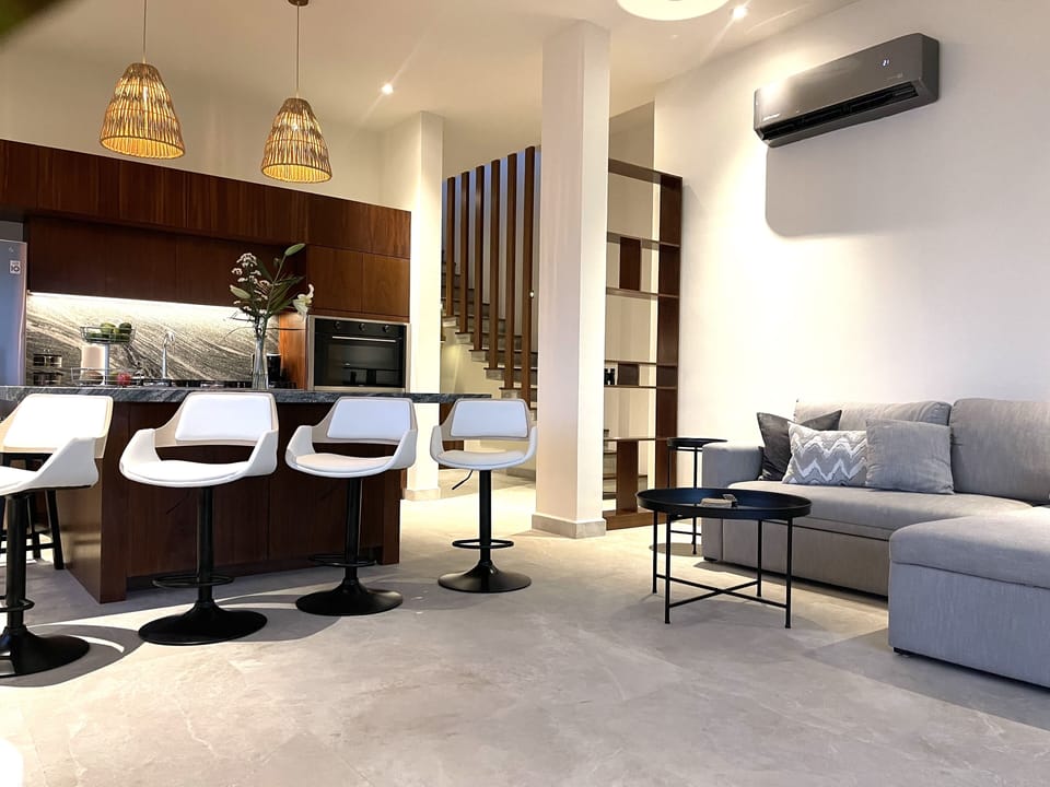 Living room with private staircase to pool deck and cabana. 
