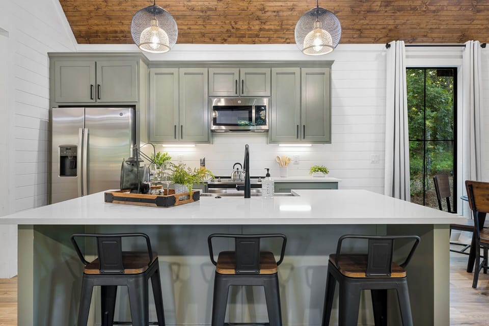 The kitchen island offers ample counter space, perfect for preparing and hosting meals.