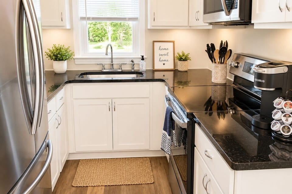 Fully equipped and thoughtfully stocked, this cozy kitchen has everything you need to prepare meals, brew your morning coffee, or enjoy a quiet evening at home. Featuring modern appliances, a Keurig coffee station with starter pods, and all the essentials