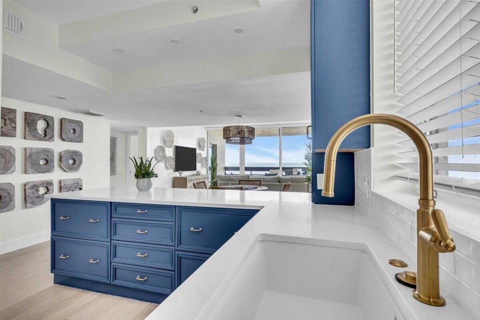 Bright, modern kitchen with ocean views and stylish blue island