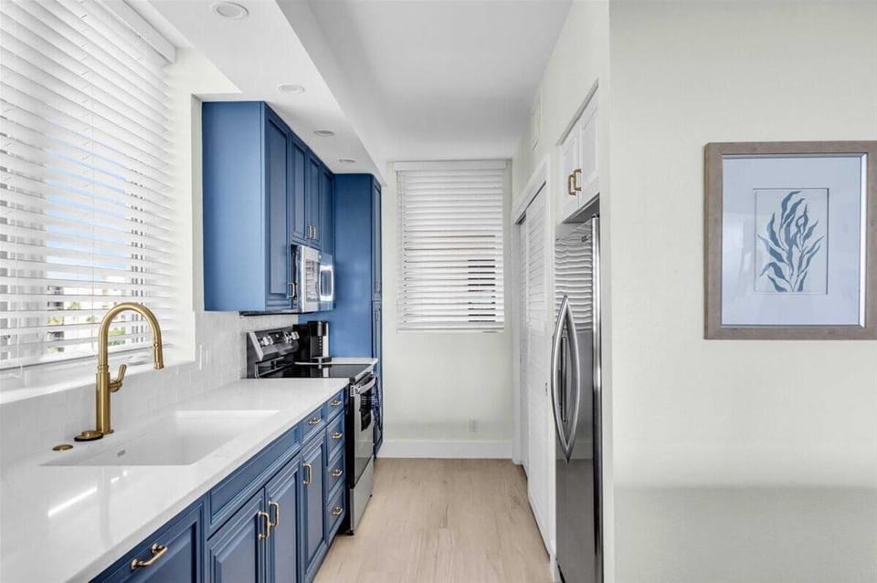 Bright kitchen with sleek blue cabinets and modern fixtures