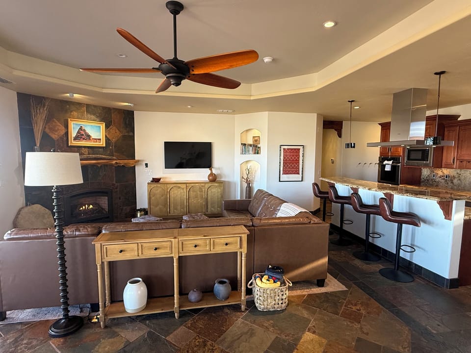 Great Room: large leather sectional, Smart TV, gas fireplace, books, games, view