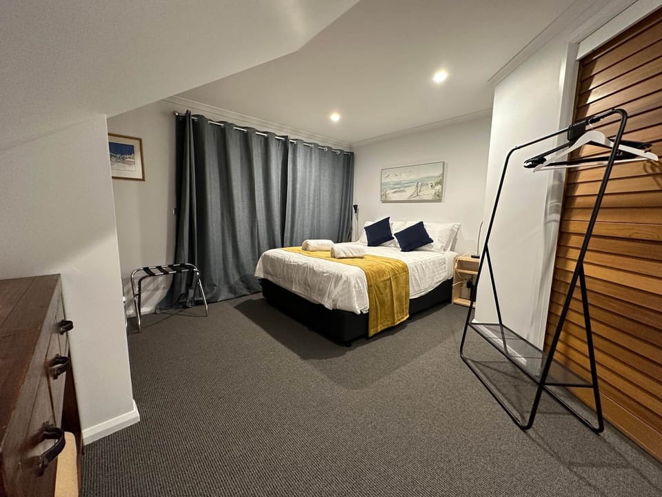 Bedroom 1 w/ Queen bed, ensuite to the right.