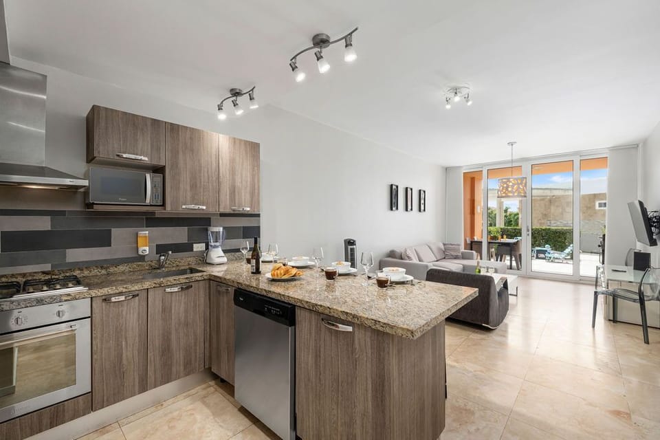 Extra dining space is provided by a kitchen island with four seats.
